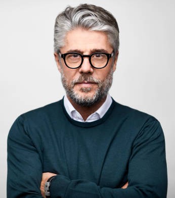 Portrait of Hispanic creative businessman. Confident mature male professional is in smart casual. He is against white background.